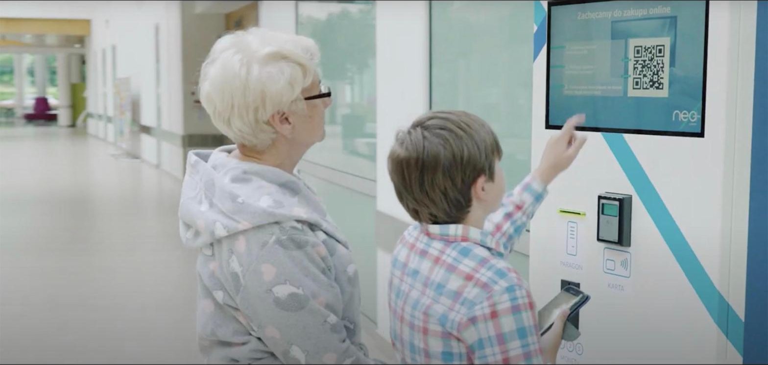 Pacjentka korzysta z kiosku Neosystem w towarzystwie bliskiej osoby